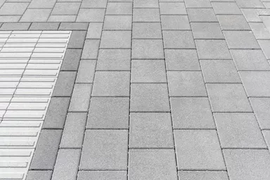 CARENA Sicherheitslinienpflasterstein Typ S Seitenstein mit Nockenverbund weiss mit 6 taktilen Linien L 37.5 cm B 25 cm H 8.4 cm